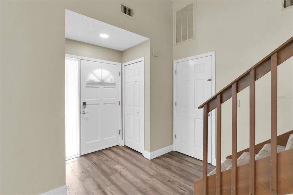 7230 Hummingbird Lane New Port Richey, FL 34655 - Photo 4 of 41 a view of an entryway with wooden floor