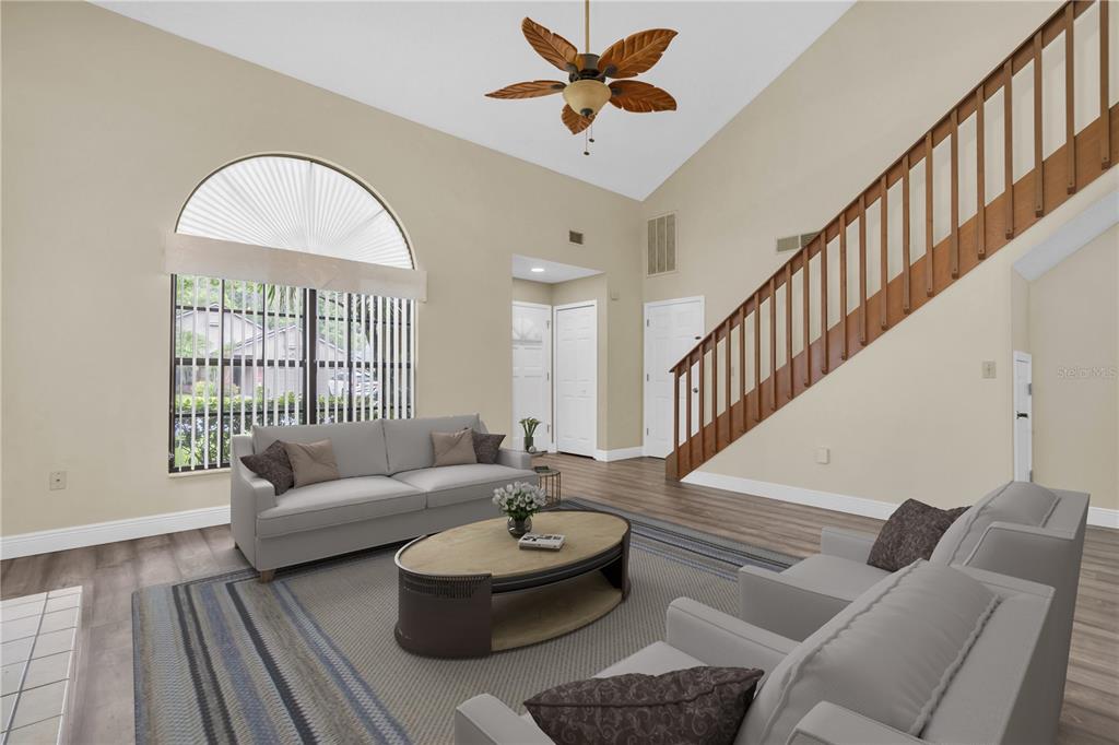 7230 Hummingbird Lane New Port Richey, FL 34655 - Photo 9 of 41 a living room with couches a table and a chandelier
