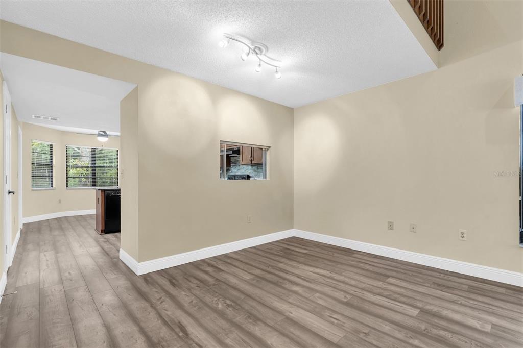 7230 Hummingbird Lane New Port Richey, FL 34655 - Photo 10 of 41 wooden floor in an empty room with a window