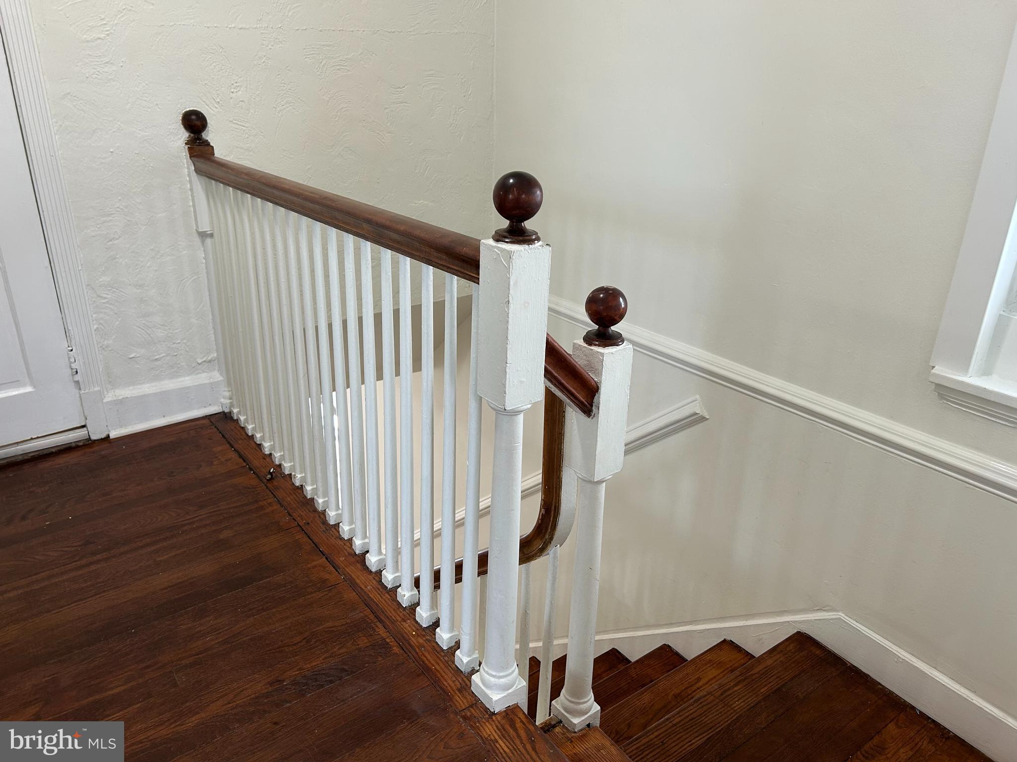 3405 Dennlyn Road Baltimore, MD 21215 - Photo 12 of 20 a view of a hallway with wooden floor and stairs