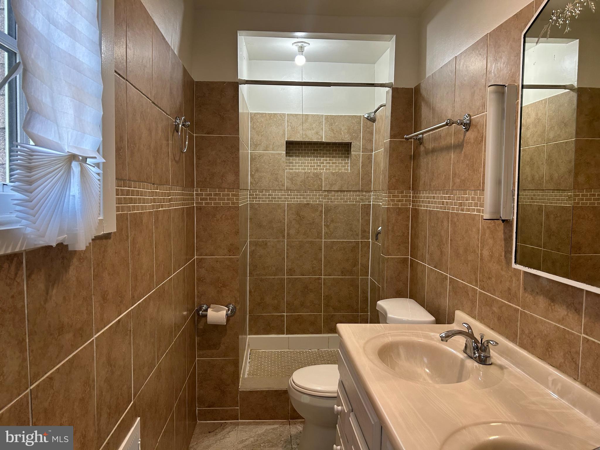 3405 Dennlyn Road Baltimore, MD 21215 - Photo 13 of 20 a bathroom with a sink toilet and shower