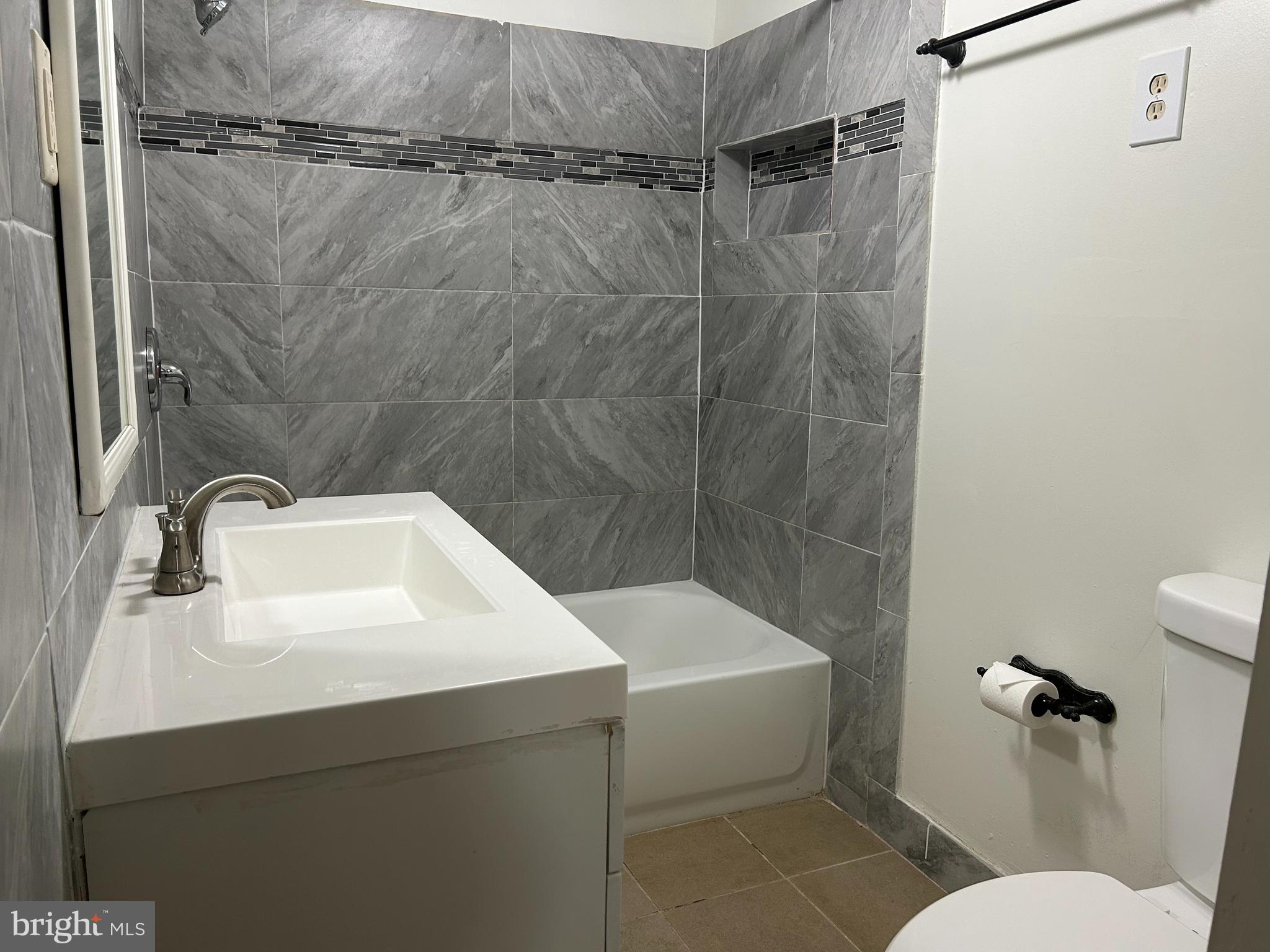 3405 Dennlyn Road Baltimore, MD 21215 - Photo 20 of 20 a bathroom with a sink a toilet and shower