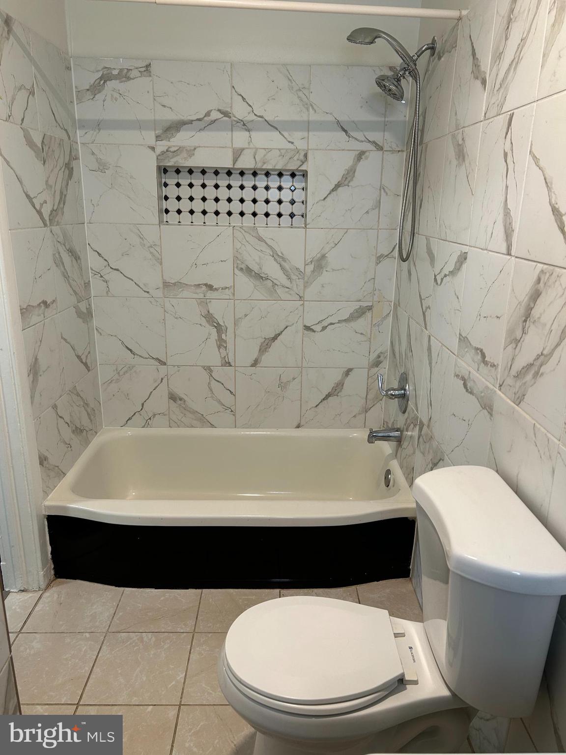 3405 Dennlyn Road Baltimore, MD 21215 - Photo 10 of 20 a bathroom with a toilet a sink and a shower