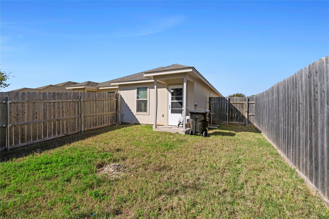 1239 Honor Lane Temple, TX 76501 - Photo 13 of 21 a view of backyard of house with wooden fence