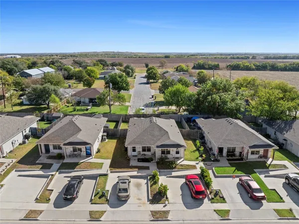 an aerial view of a houses with a city view