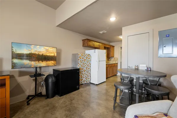 a living room with furniture a flat screen tv and a window