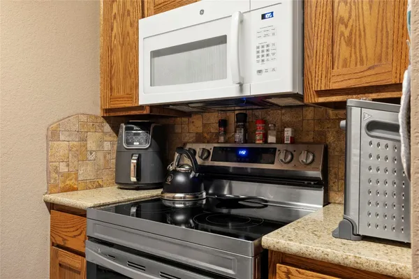 a kitchen with a stove and a microwave