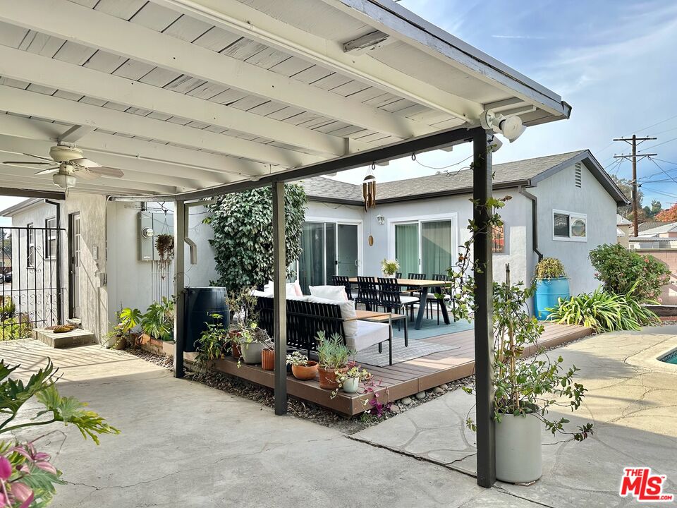 2132 Mcpherson Place Los Angeles, CA 90032 - Photo 4 of 28 a view of a patio with table and chairs potted plants and floor to ceiling window