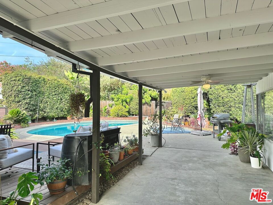 2132 Mcpherson Place Los Angeles, CA 90032 - Photo 5 of 28 a view of a patio with table and chairs potted plants with floor to ceiling windows