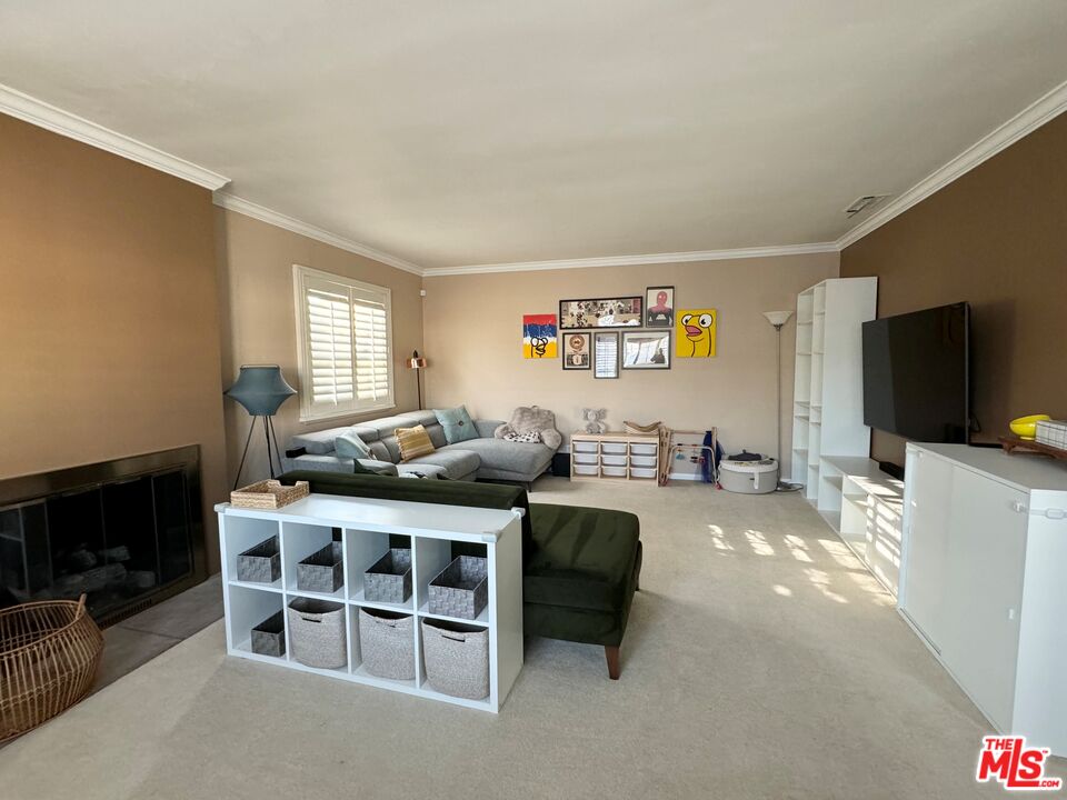 2132 Mcpherson Place Los Angeles, CA 90032 - Photo 7 of 28 a living room with furniture a flat screen tv and a fireplace