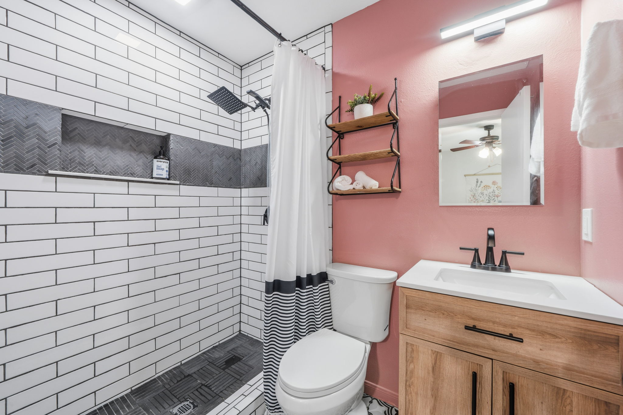 705 Dulwich Street Austin, TX 78748 - Photo 15 of 36 A well-appointed bath features a tiled shower and a modern vanity, offering comfort and convenience.