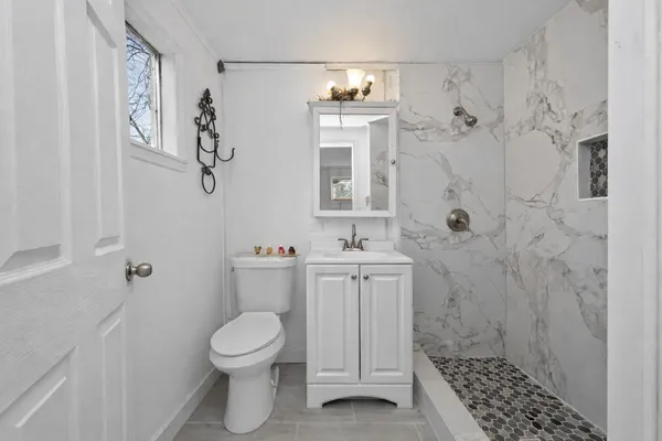 a bathroom with a toilet and a shower