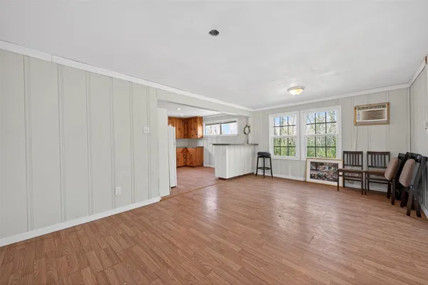 a view of a livingroom with hardwood and furniture