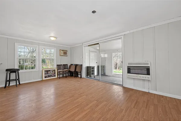 an empty room with furniture and large windows