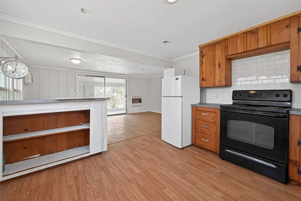a kitchen with granite countertop wooden floors and wide window