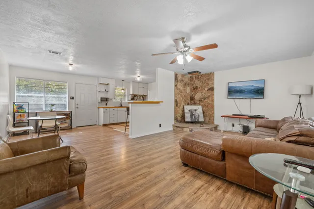 a living room with furniture and kitchen view
