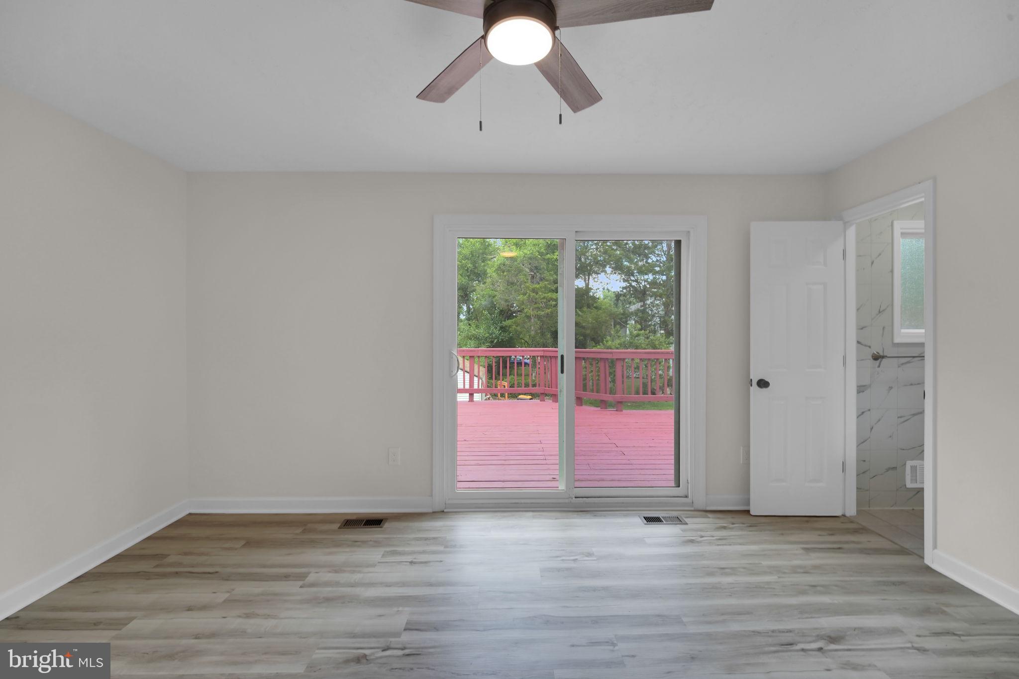 8613 Weems Road Manassas, VA 20110 - Photo 15 of 50 a view of an empty room with wooden floor and window