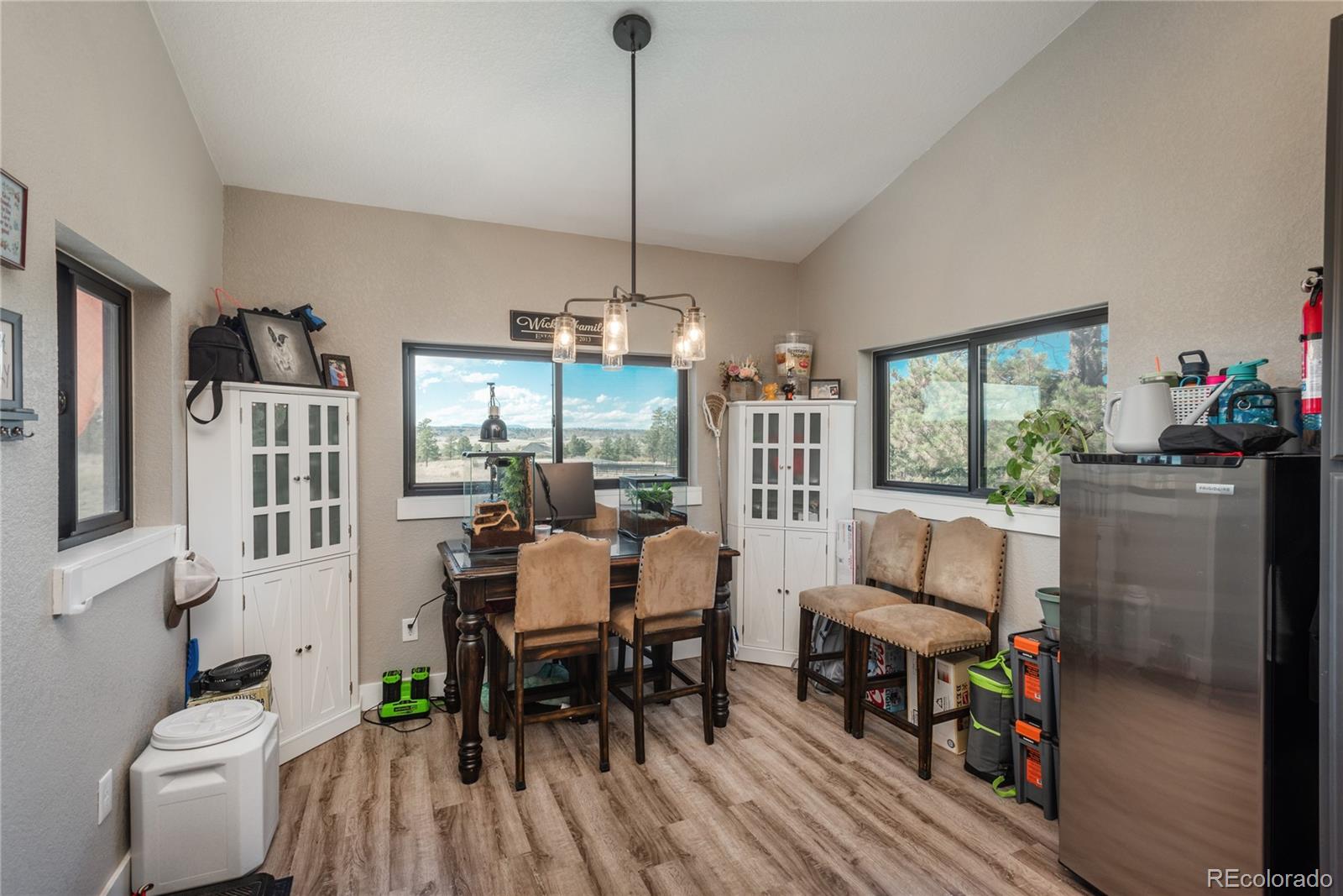 854 Russellville Road Franktown, CO 80116 - Photo 22 of 35 a view of a dining room with furniture window and wooden floor