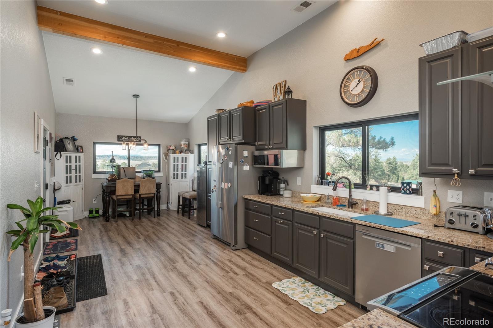 854 Russellville Road Franktown, CO 80116 - Photo 23 of 35 a large kitchen with a large window and stainless steel appliances