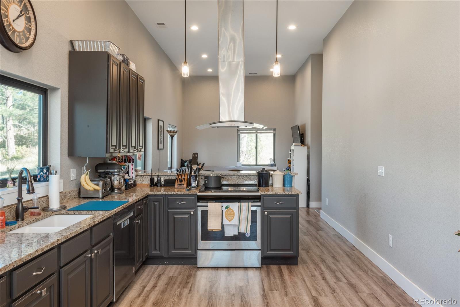 854 Russellville Road Franktown, CO 80116 - Photo 25 of 35 a kitchen with stainless steel appliances granite countertop a sink a stove and a wooden floors
