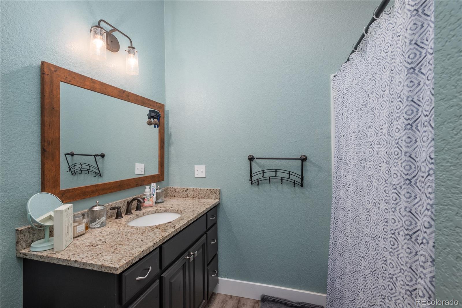 854 Russellville Road Franktown, CO 80116 - Photo 30 of 35 a bathroom with a sink and a mirror