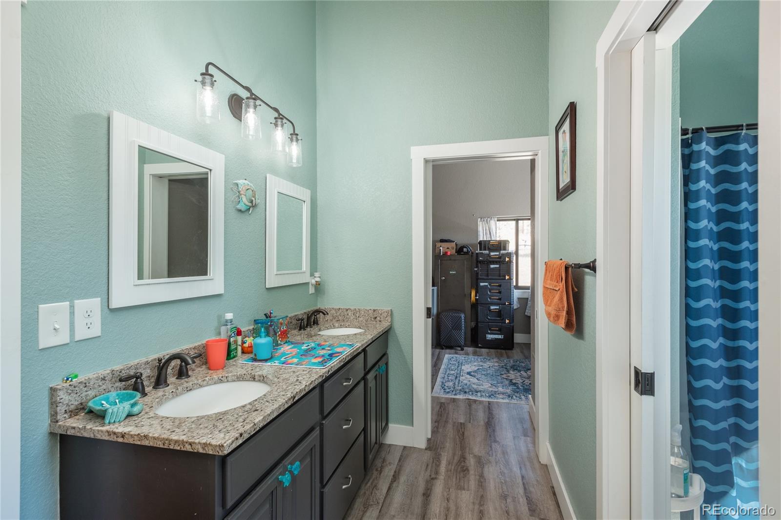 854 Russellville Road Franktown, CO 80116 - Photo 31 of 35 a bathroom with a granite countertop sink and a mirror