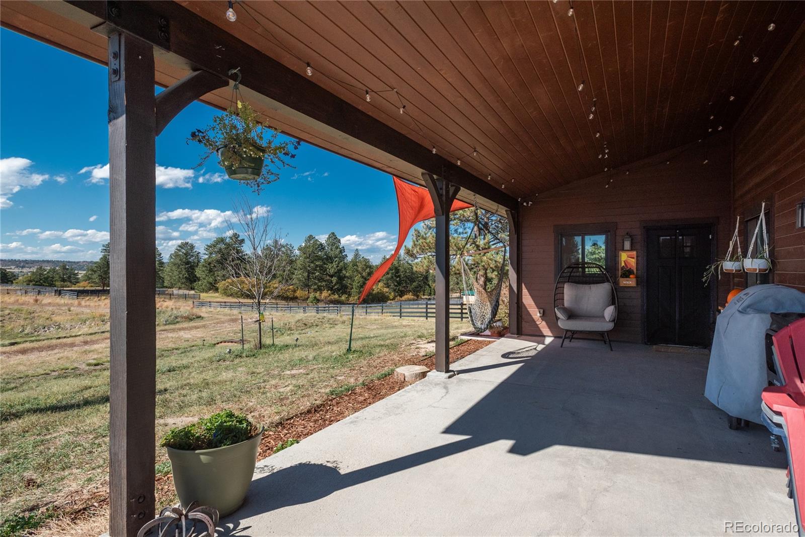854 Russellville Road Franktown, CO 80116 - Photo 35 of 35 a view of a floor to ceiling window and an outdoor kitchen