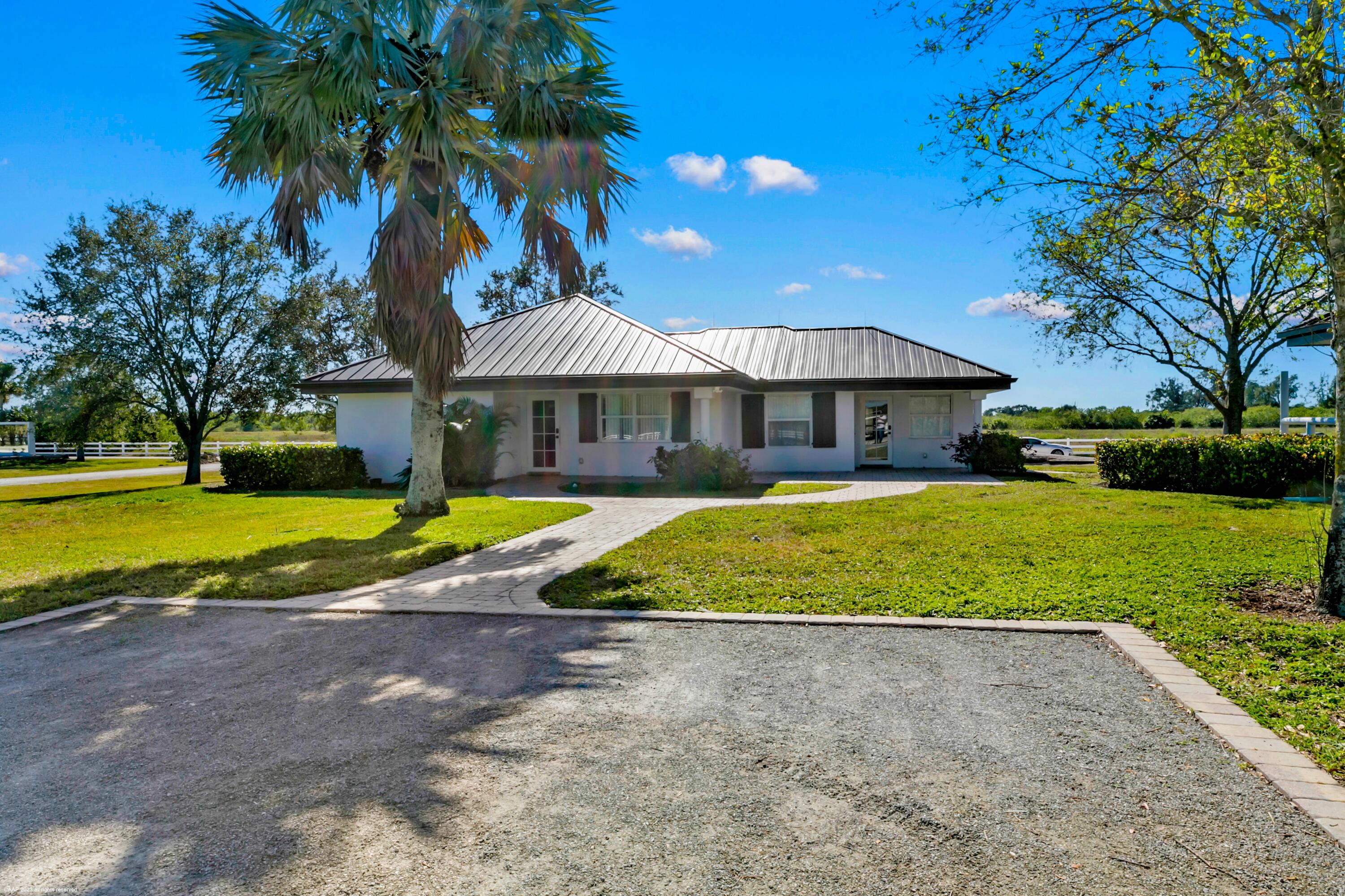 3790 Hanover Circle Loxahatchee, FL 33470 - Photo 16 of 73 a view of a house with swimming pool and a yard