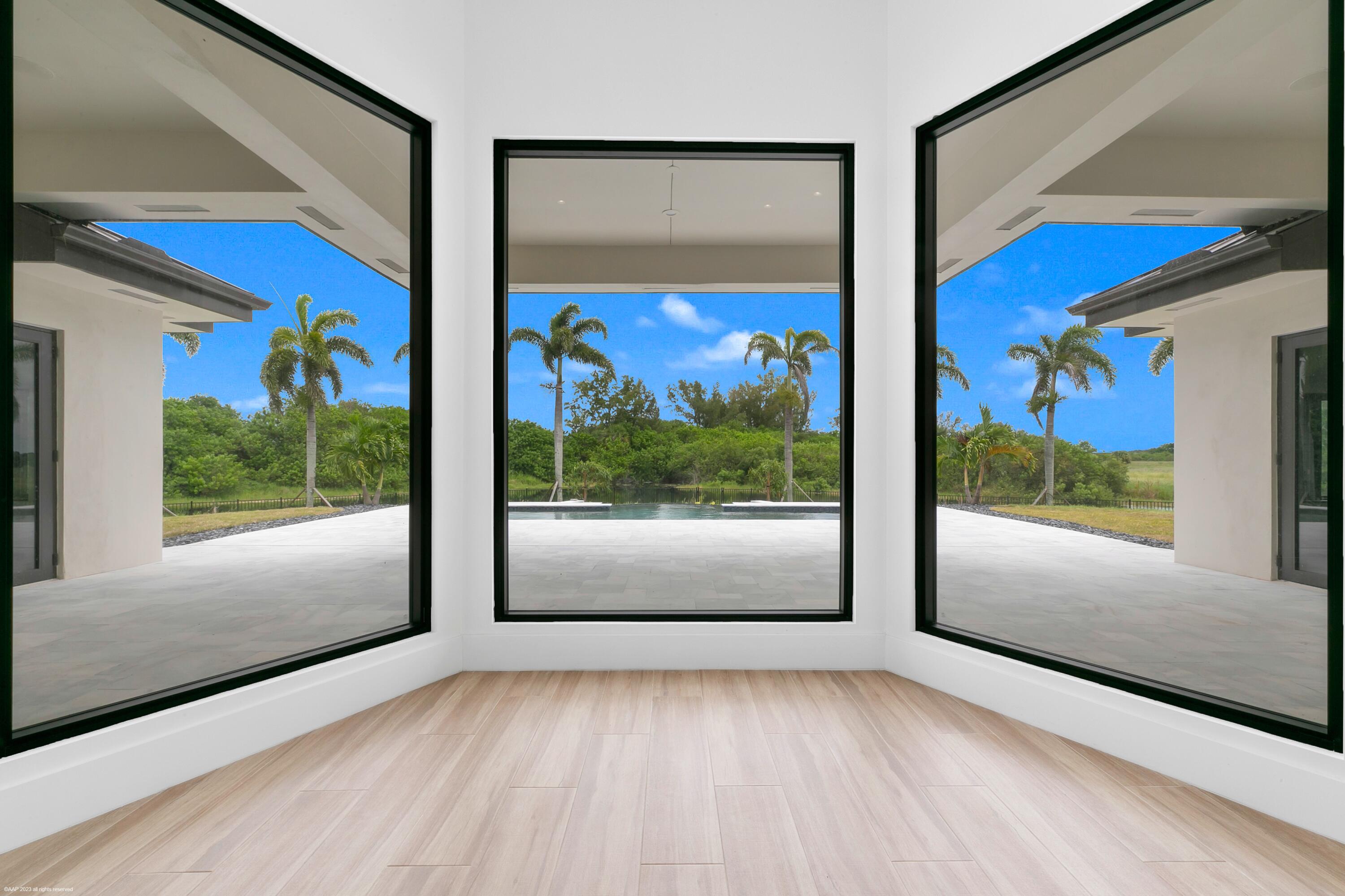 3790 Hanover Circle Loxahatchee, FL 33470 - Photo 49 of 73 a view of a large window with swimming pool in front of it