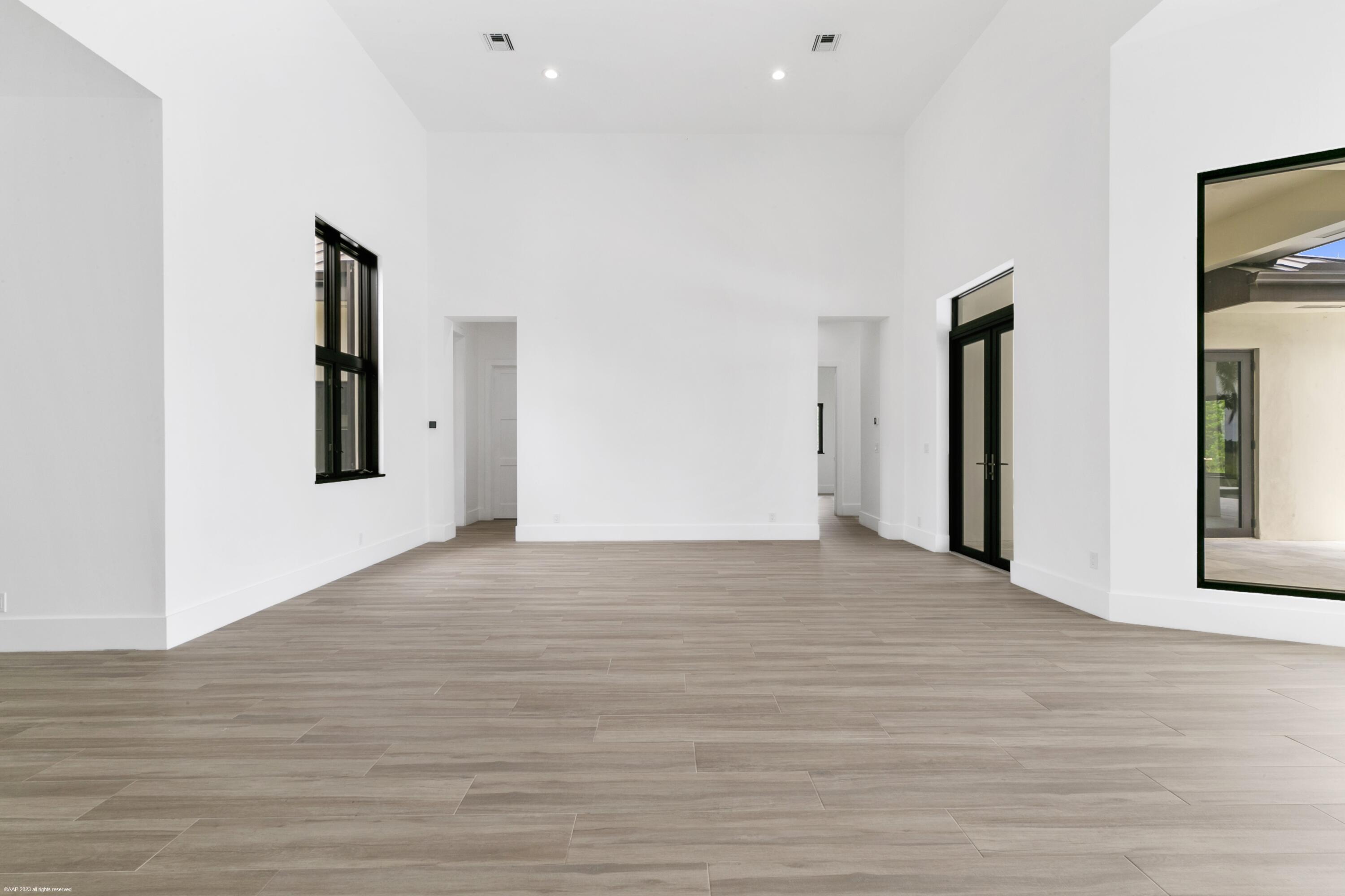 3790 Hanover Circle Loxahatchee, FL 33470 - Photo 52 of 73 a view of an empty room with wooden floor and windows