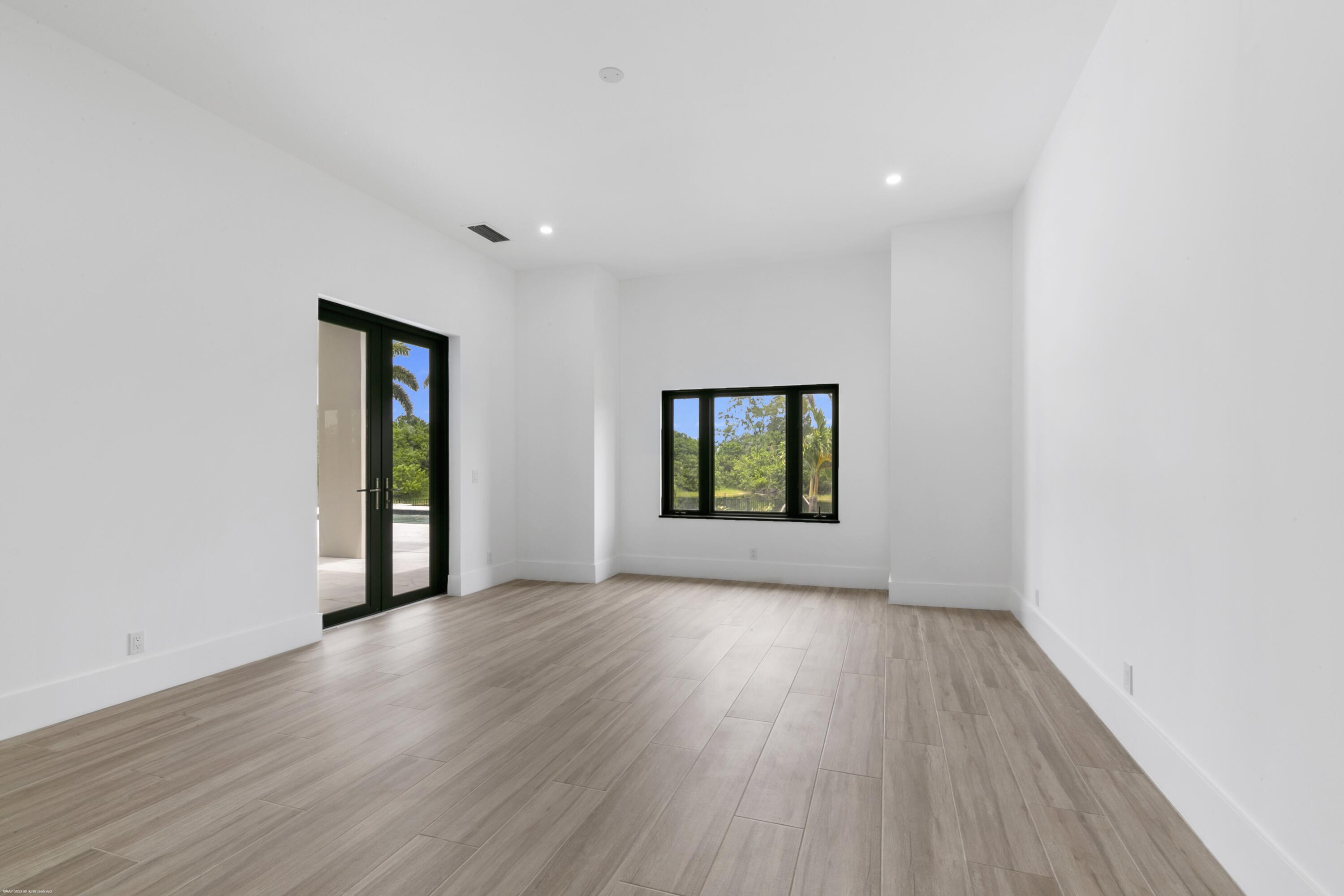 3790 Hanover Circle Loxahatchee, FL 33470 - Photo 57 of 73 an empty room with wooden floor and windows