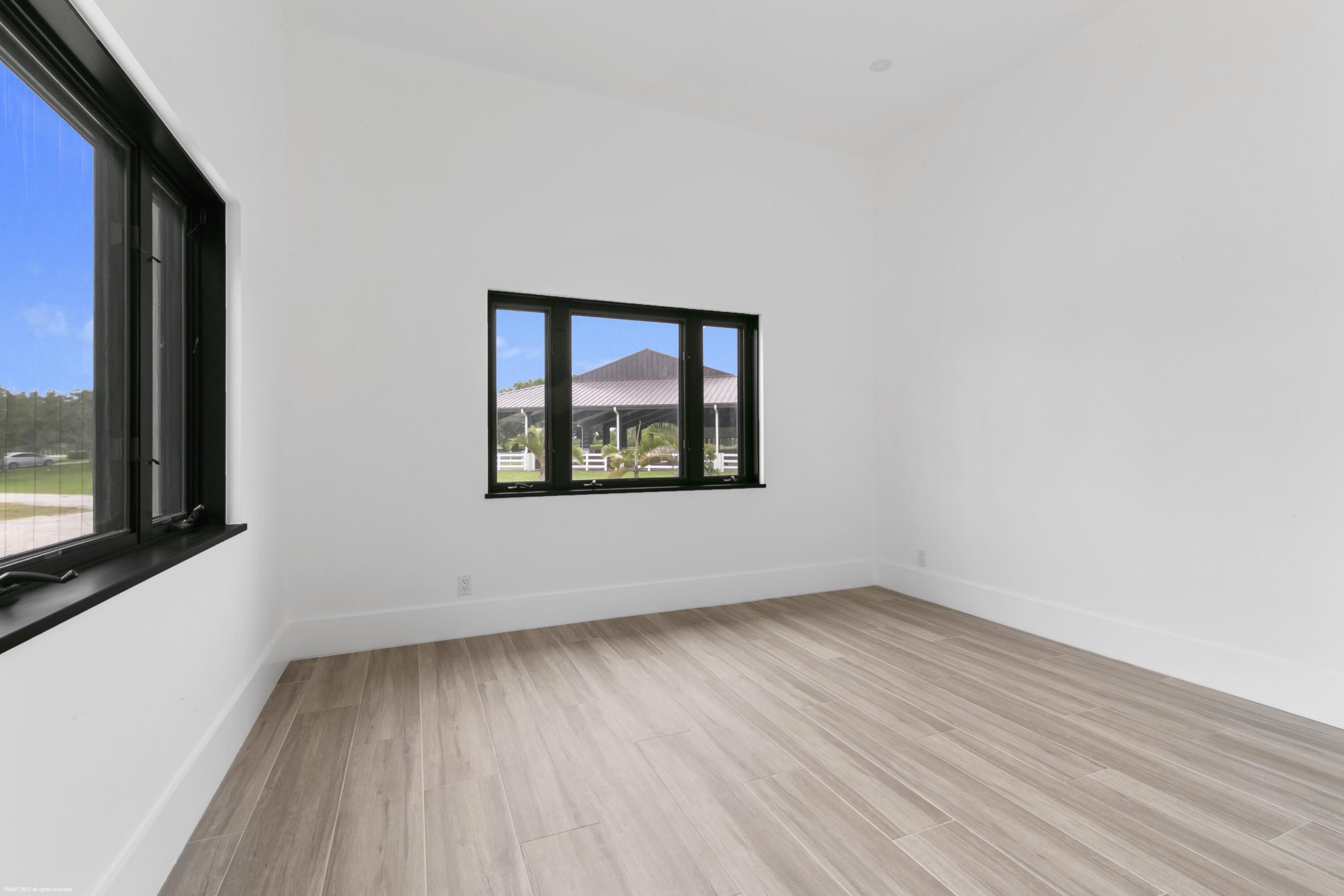 3790 Hanover Circle Loxahatchee, FL 33470 - Photo 63 of 73 a view of an empty room with wooden floor and a window