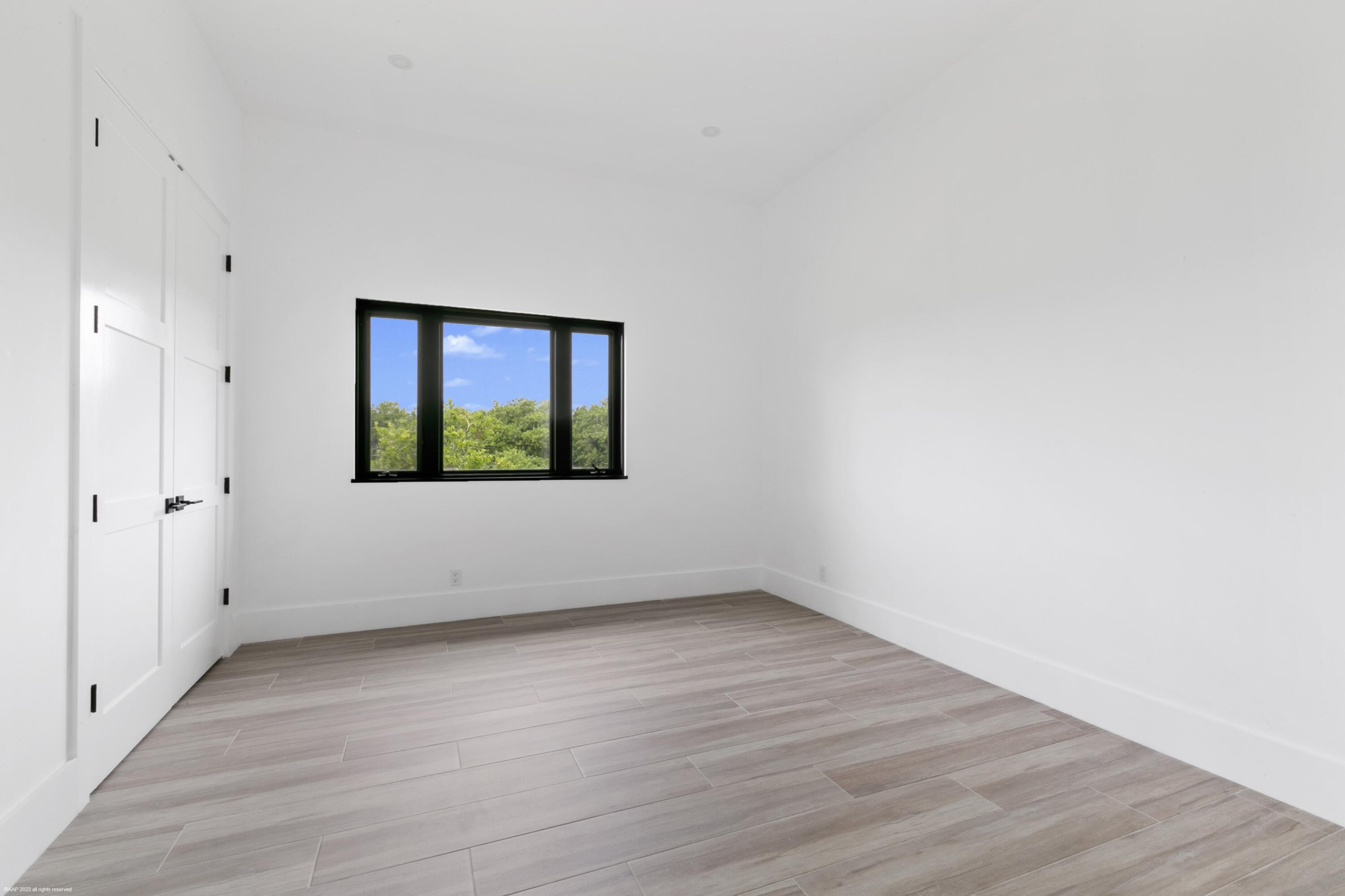 3790 Hanover Circle Loxahatchee, FL 33470 - Photo 65 of 73 a view of an empty room with wooden floor and a window