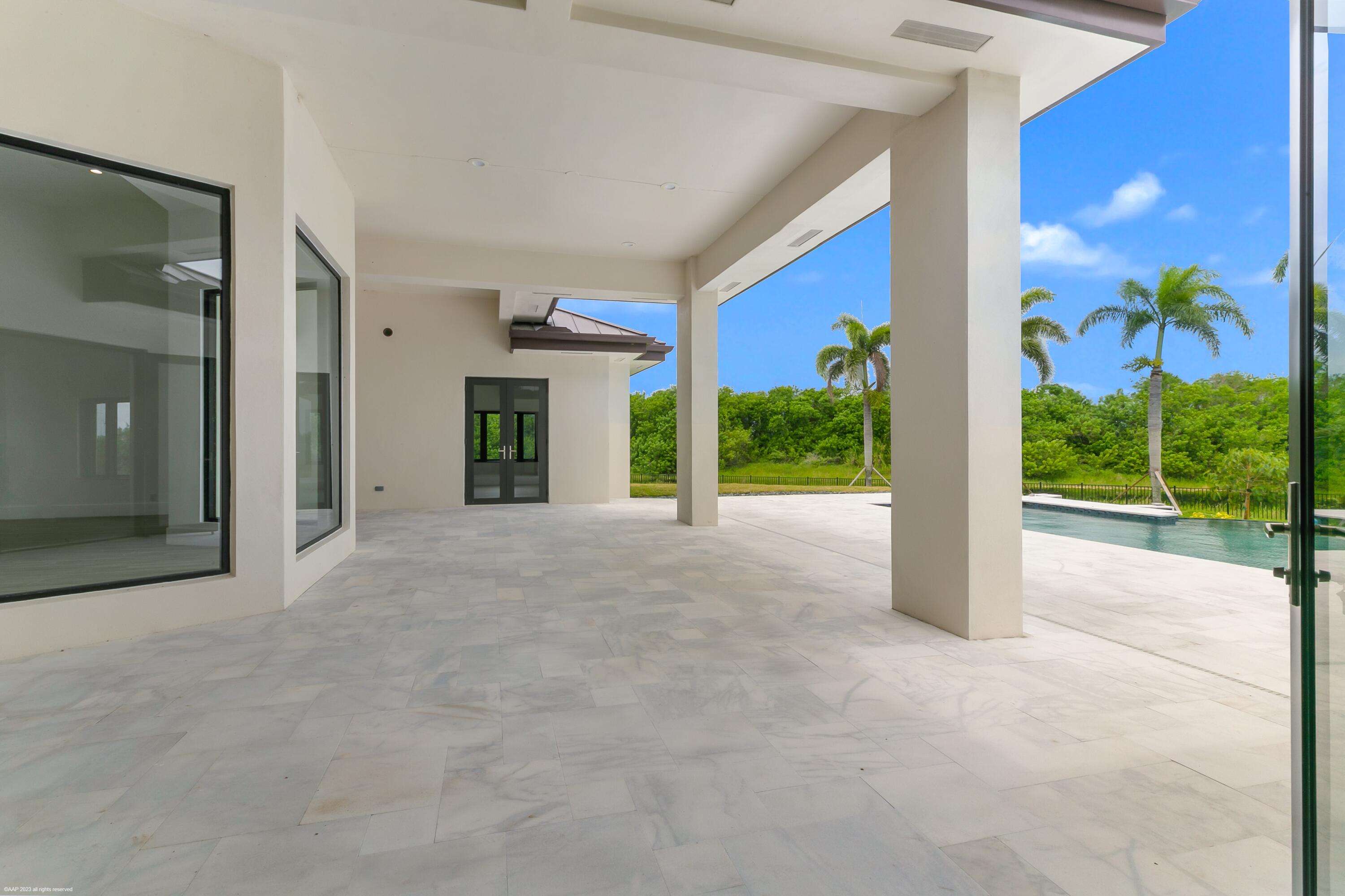 3790 Hanover Circle Loxahatchee, FL 33470 - Photo 69 of 73 a view of a house with porch and potted plants
