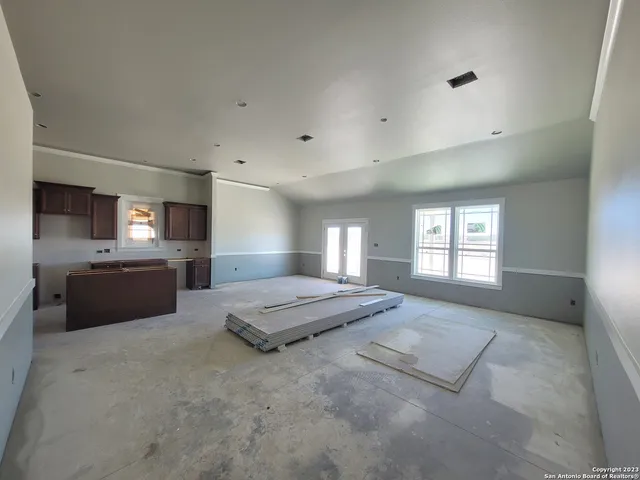 a spacious bathroom with a granite countertop sink and a mirror