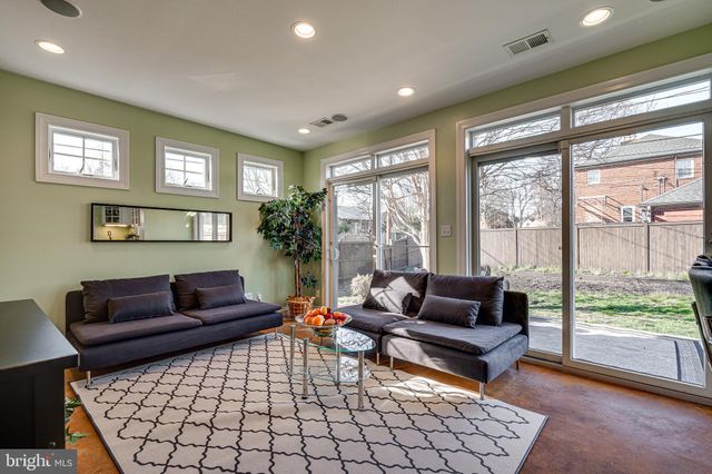 a living room with furniture rug and window