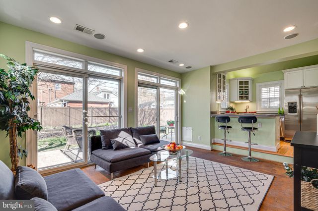 a bedroom with a bed and a potted plant on the dresser