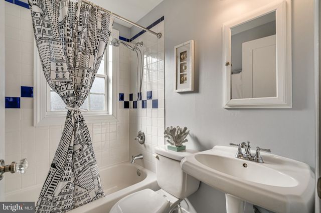 a bathroom with a granite countertop sink mirror and shower