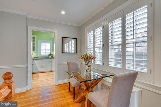 a kitchen with granite countertop a sink a window and cabinets