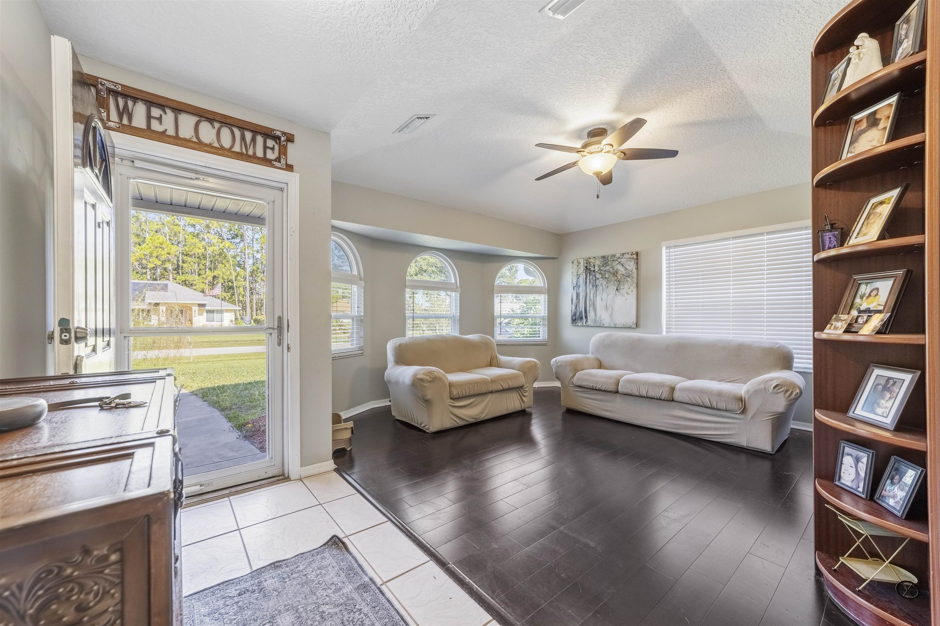 311 Graciela Circle St. Augustine, FL 32086 - Photo 11 of 65 Living room featuring a textured ceiling, ceiling fan, and light wood-style floors