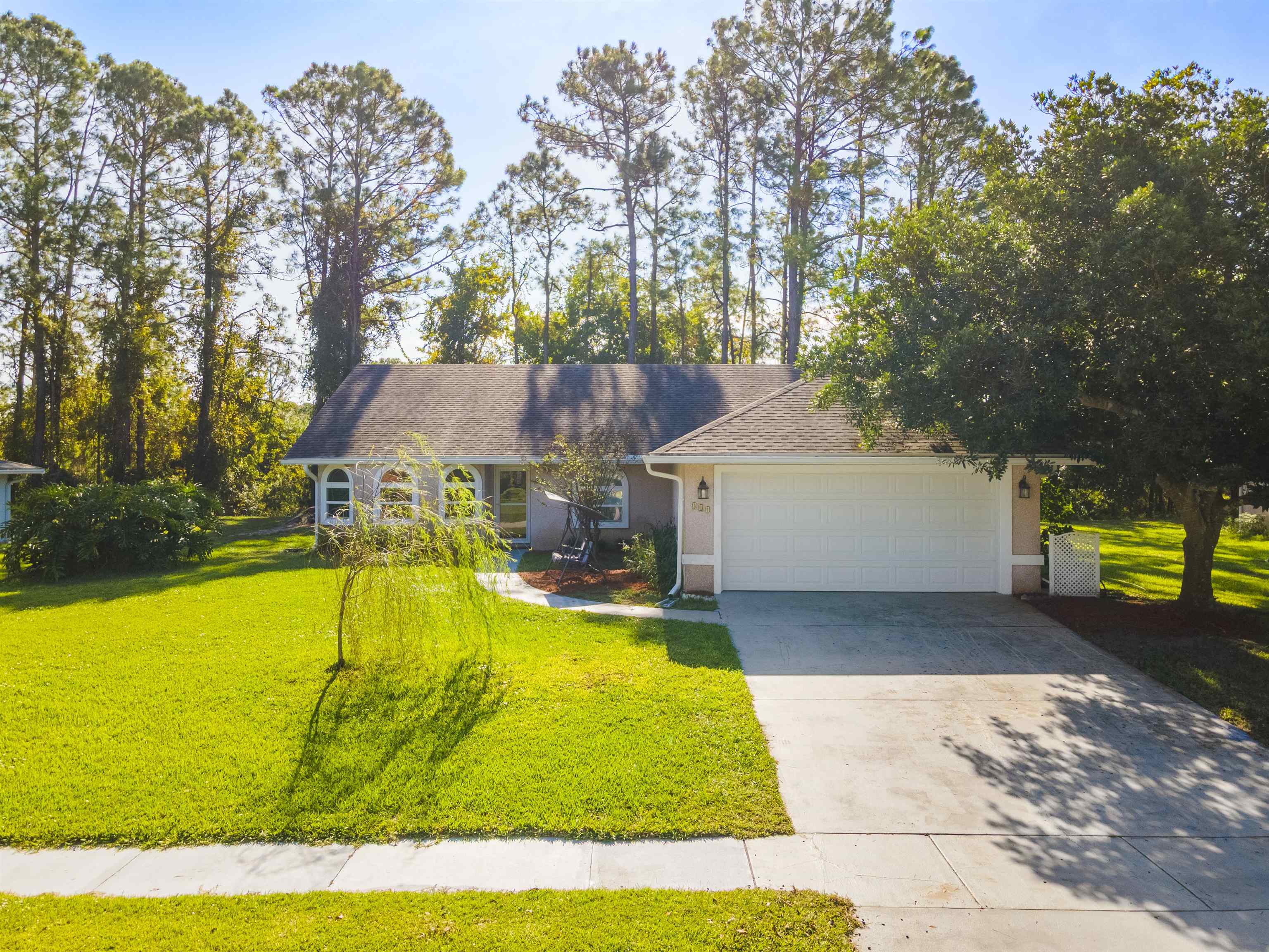 311 Graciela Circle St. Augustine, FL 32086 - Photo 2 of 65 View of front of house featuring a front lawn, driveway, a shingled roof, and a garage