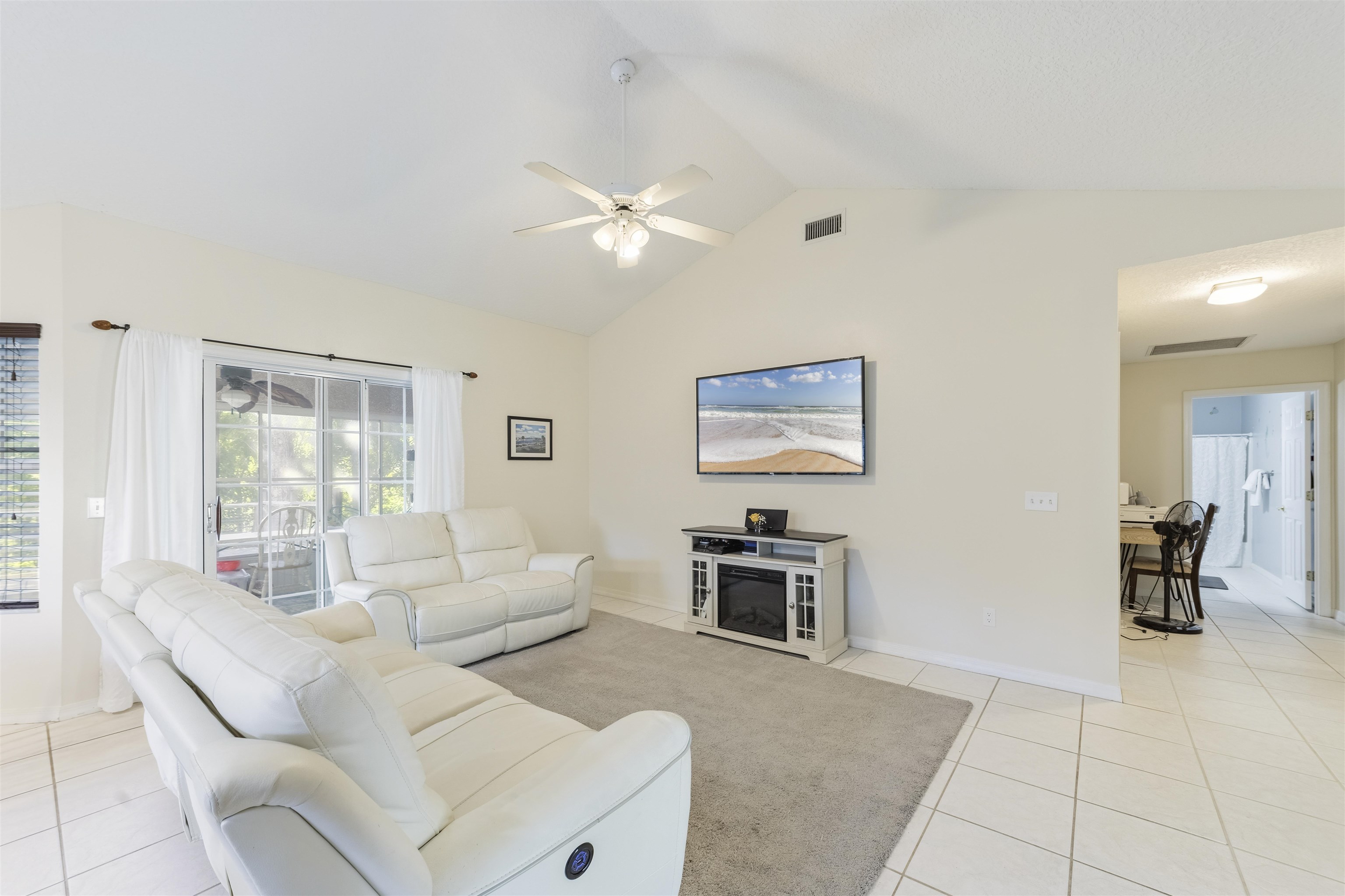 311 Graciela Circle St. Augustine, FL 32086 - Photo 24 of 65 Living area with light tile patterned flooring, lofted ceiling, and ceiling fan