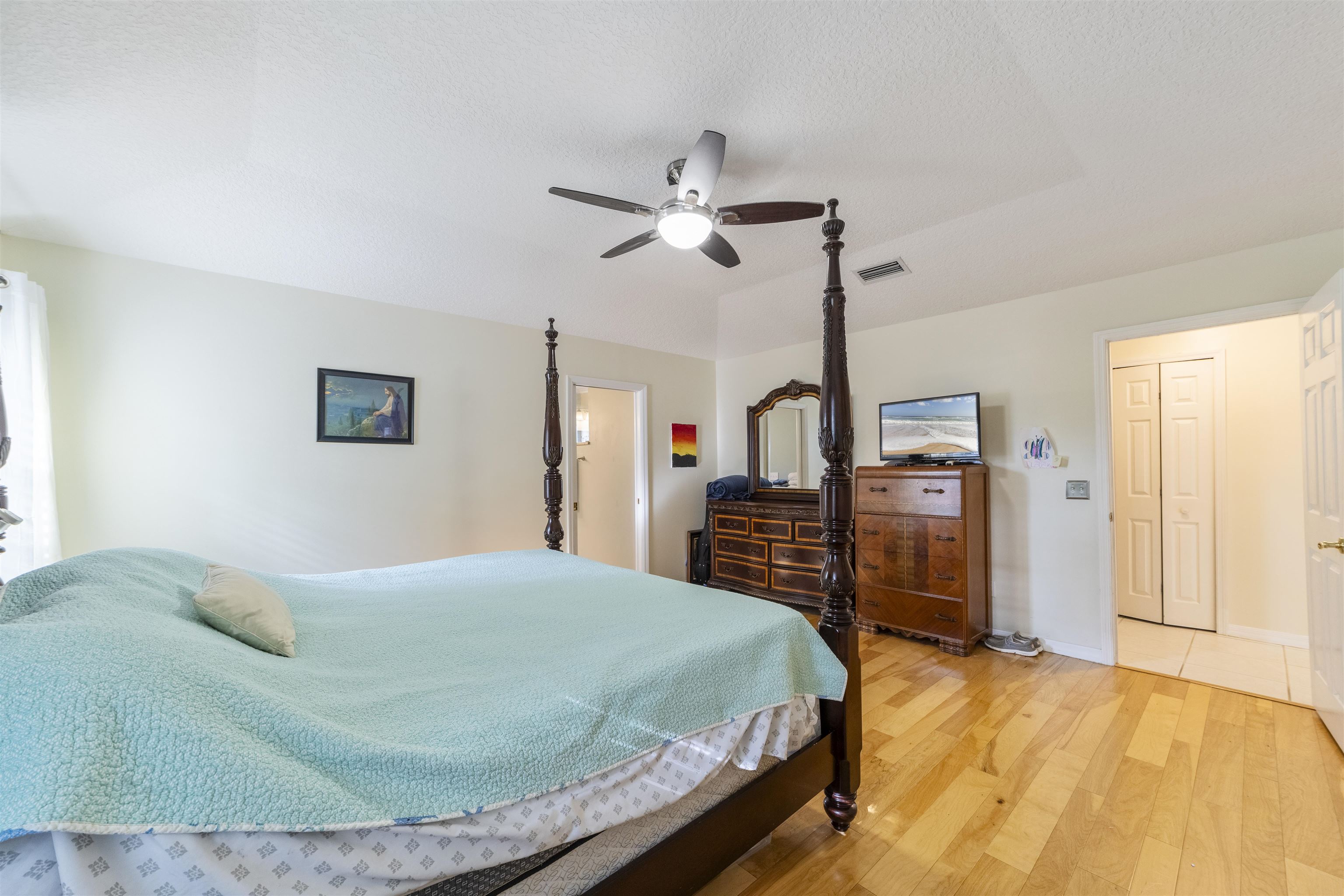 311 Graciela Circle St. Augustine, FL 32086 - Photo 36 of 65 Bedroom featuring light wood-type flooring, ceiling fan, and a textured ceiling