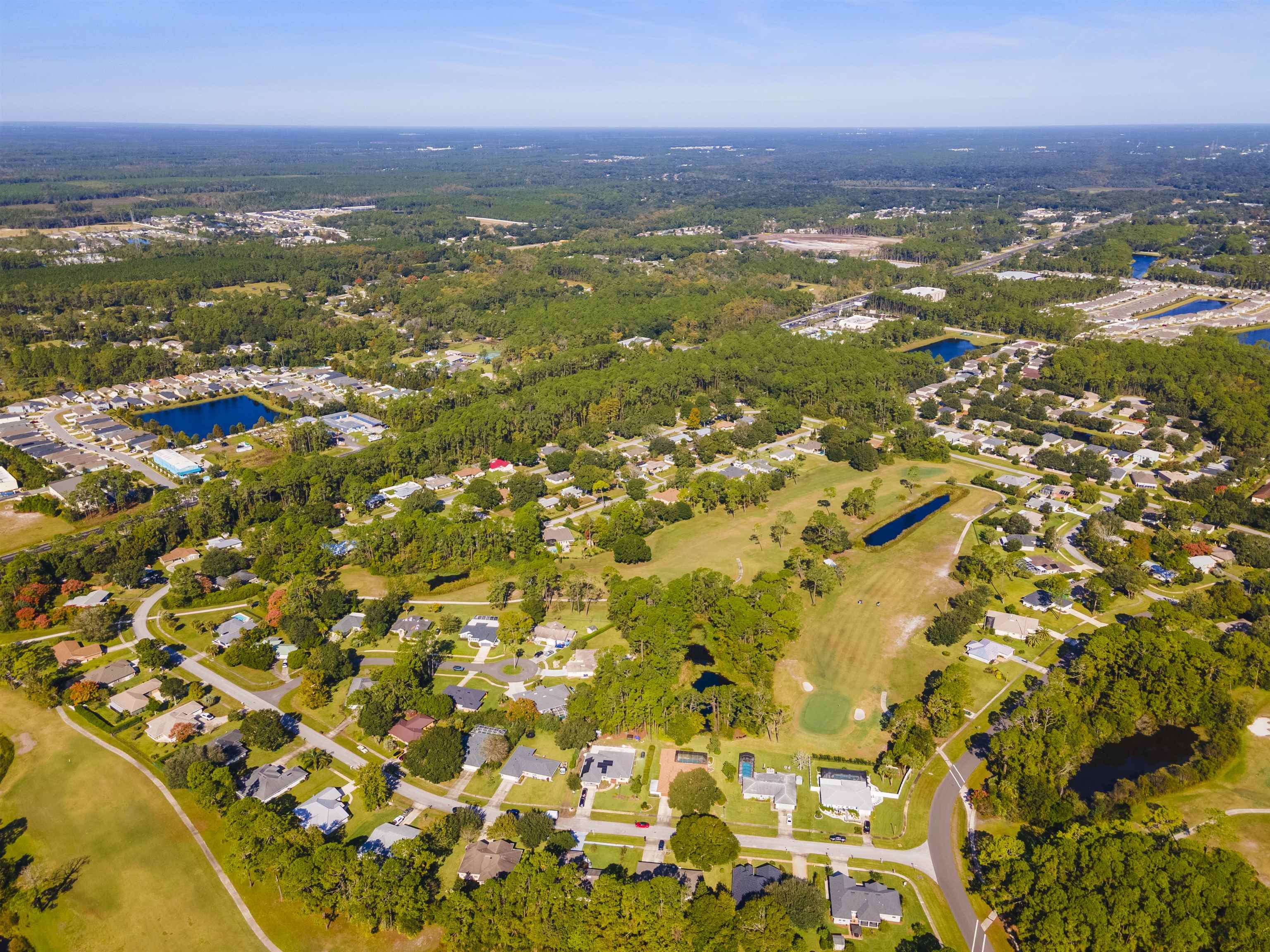 311 Graciela Circle St. Augustine, FL 32086 - Photo 4 of 65 Aerial view of property and surrounding area featuring nearby suburban area, a golf club, and a large body of water