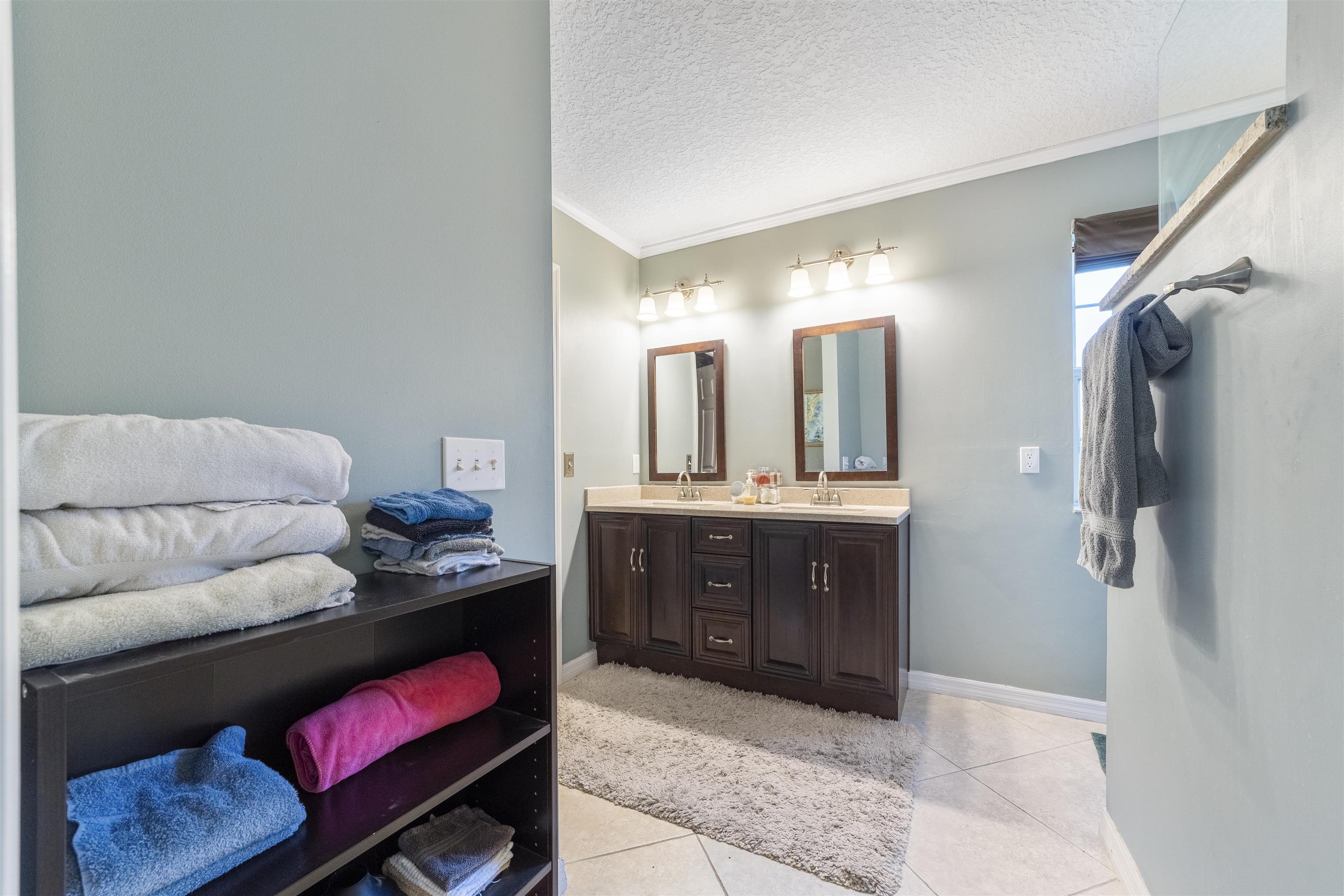 311 Graciela Circle St. Augustine, FL 32086 - Photo 41 of 65 Full bathroom featuring ornamental molding, double vanity, a textured ceiling, and light tile patterned flooring