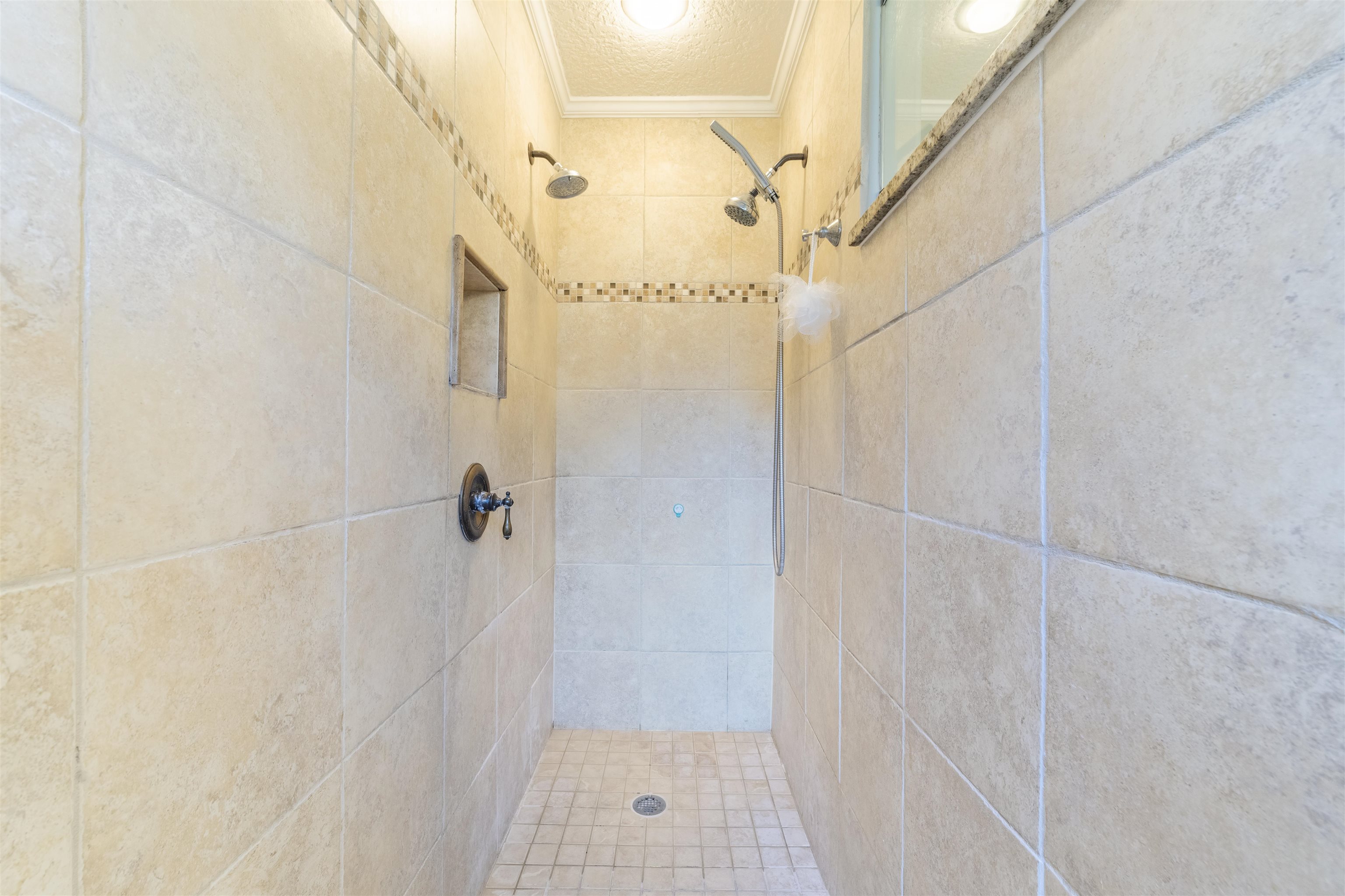 311 Graciela Circle St. Augustine, FL 32086 - Photo 42 of 65 Bathroom with crown molding, a tile shower, and a textured ceiling