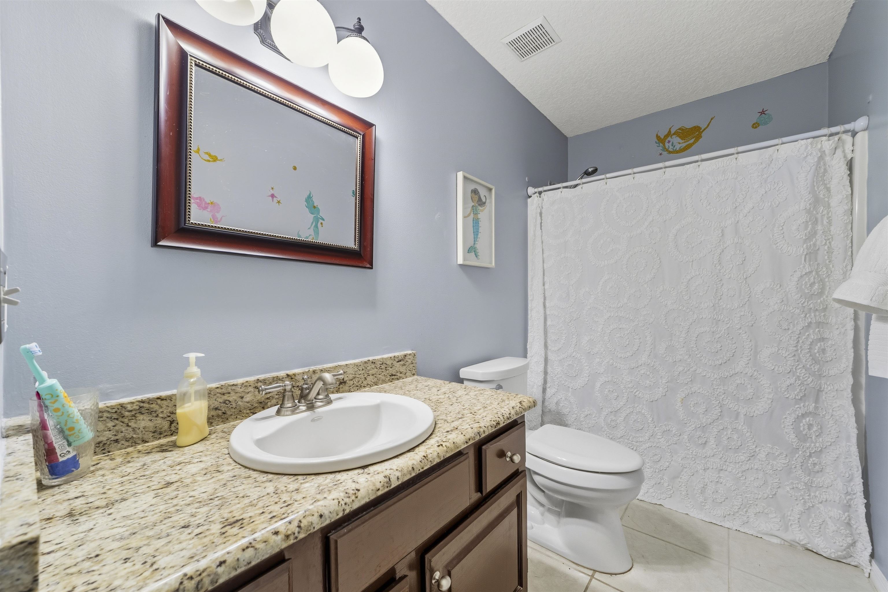 311 Graciela Circle St. Augustine, FL 32086 - Photo 50 of 65 Bathroom with a shower with curtain, vanity, light tile patterned floors, and a textured ceiling