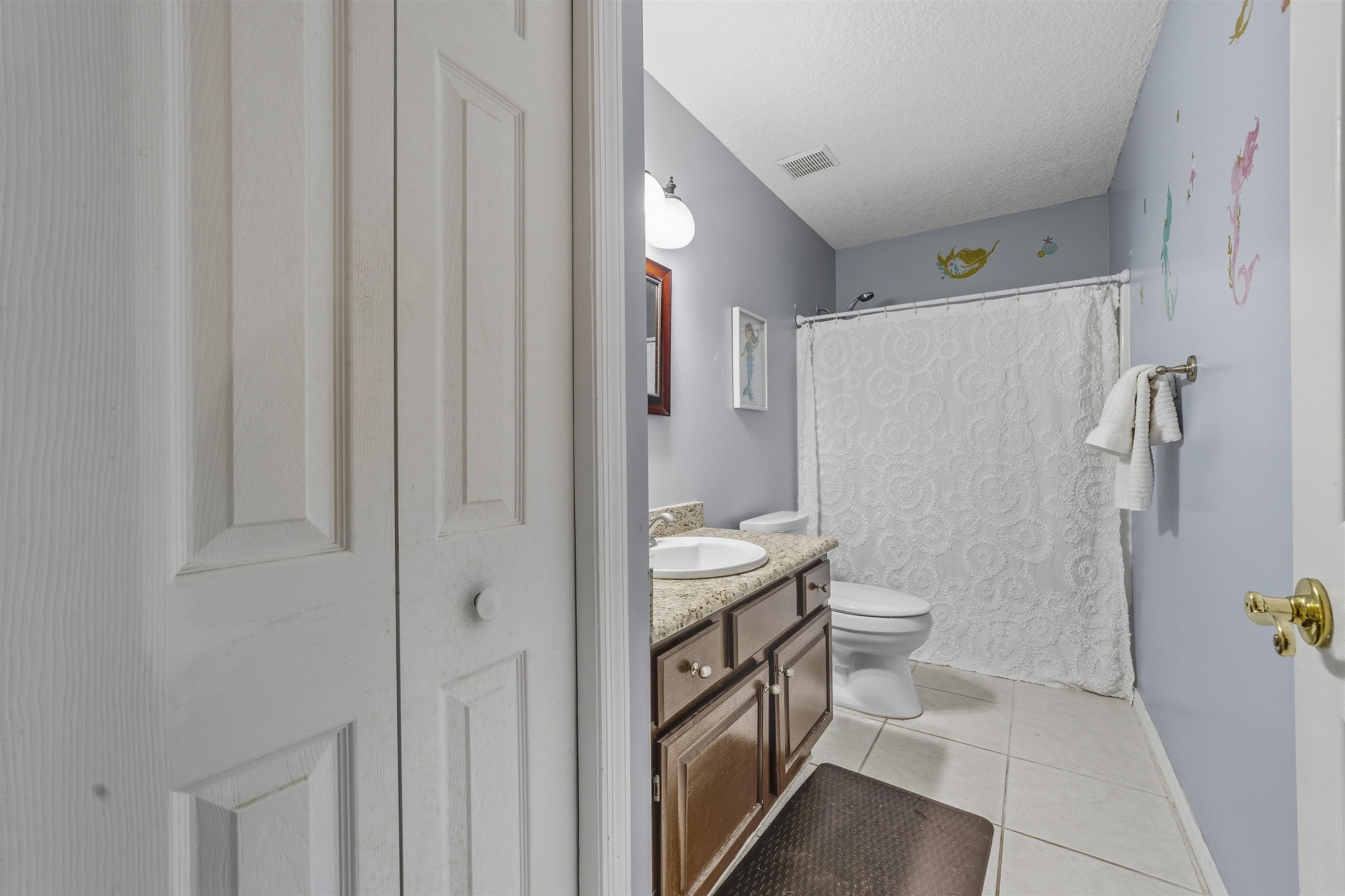 311 Graciela Circle St. Augustine, FL 32086 - Photo 52 of 65 Full bathroom with vanity, curtained shower, light tile patterned floors, a textured ceiling, and a closet