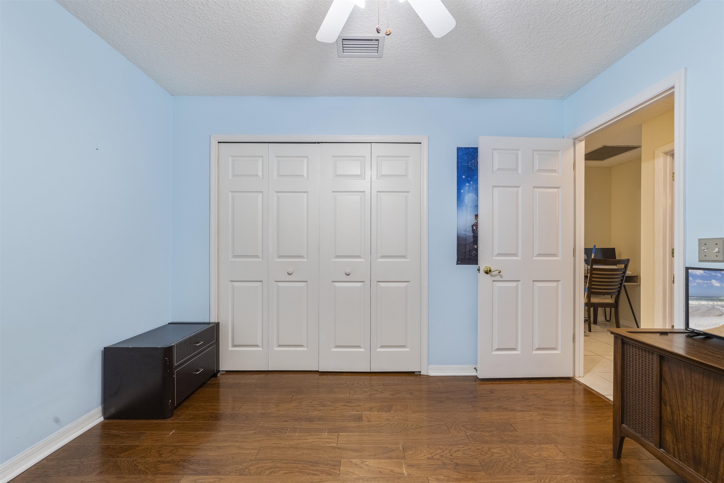 311 Graciela Circle St. Augustine, FL 32086 - Photo 53 of 65 Bedroom featuring dark wood-style flooring, a closet, a textured ceiling, and ceiling fan