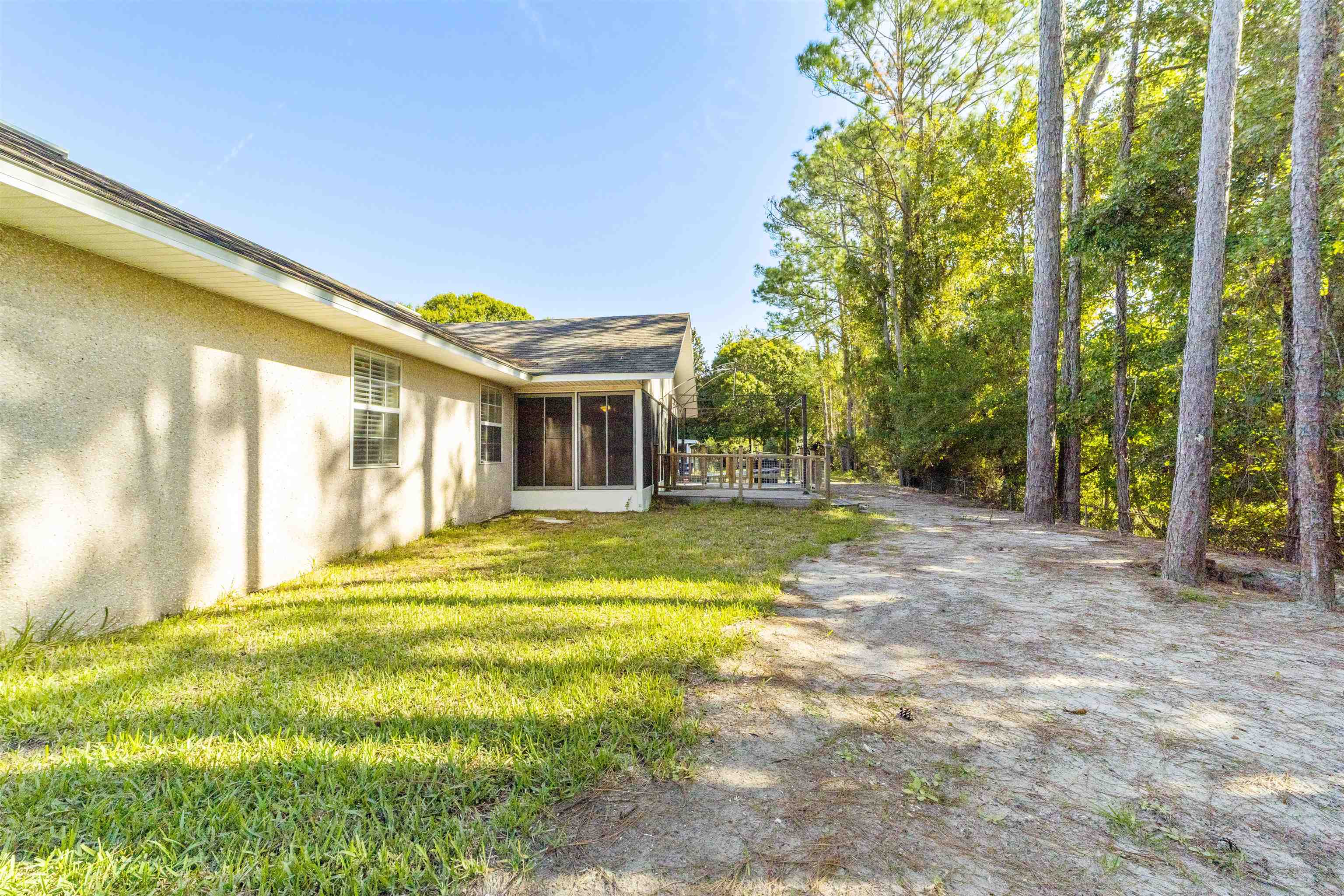 311 Graciela Circle St. Augustine, FL 32086 - Photo 59 of 65 View of green lawn with a sunroom and a wooden deck